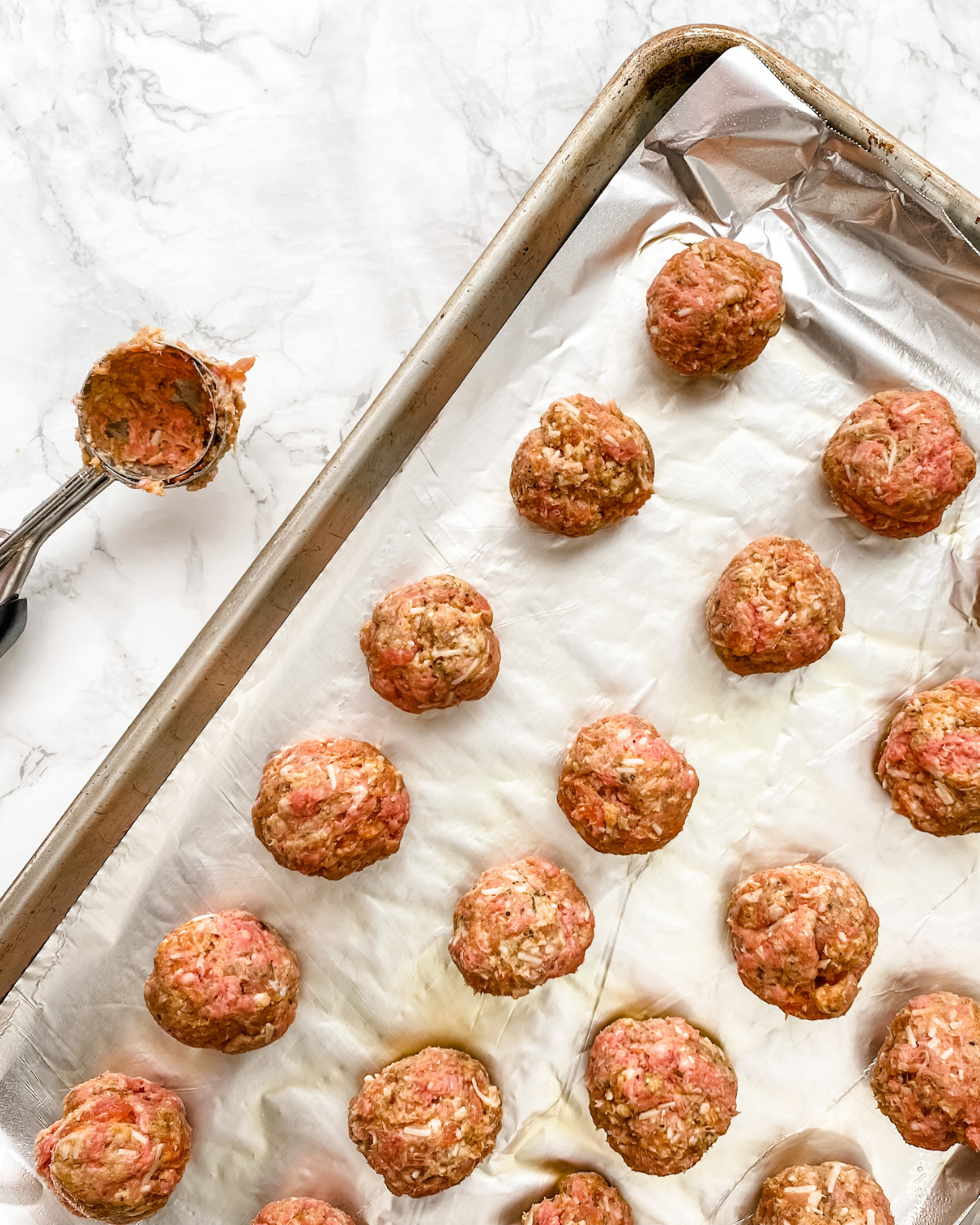 gf raw meatballs on a sheetpan