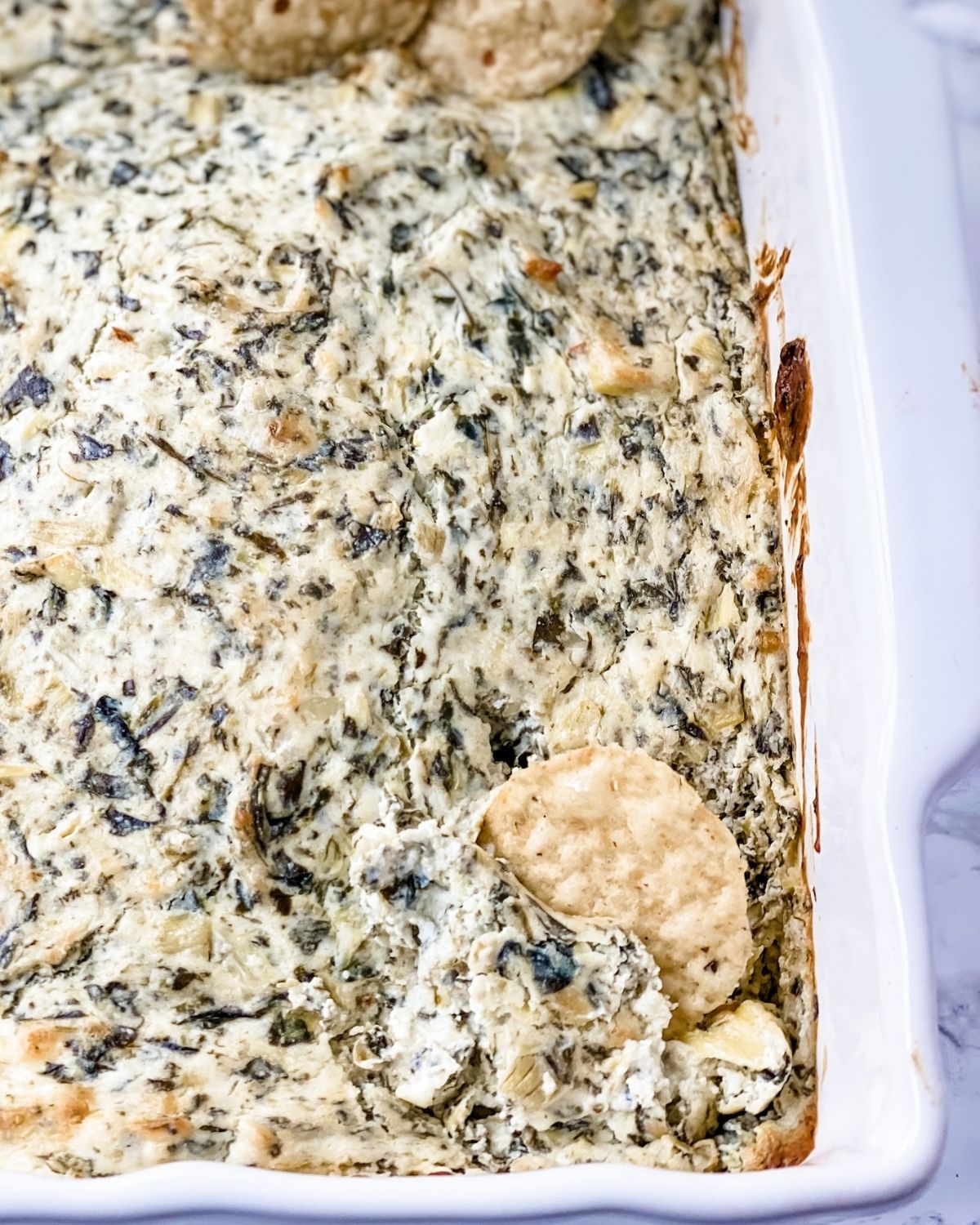 overhead picture of spinach artichoke dip with gluten-free cracker