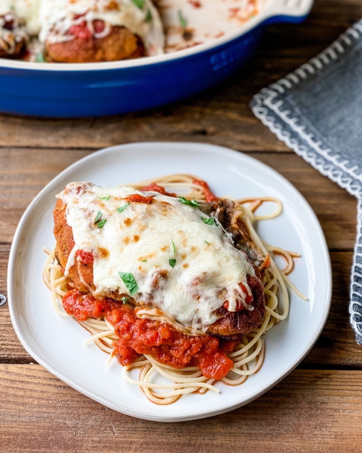 gluten-free Chicken Parmesan on a plate with pasta.