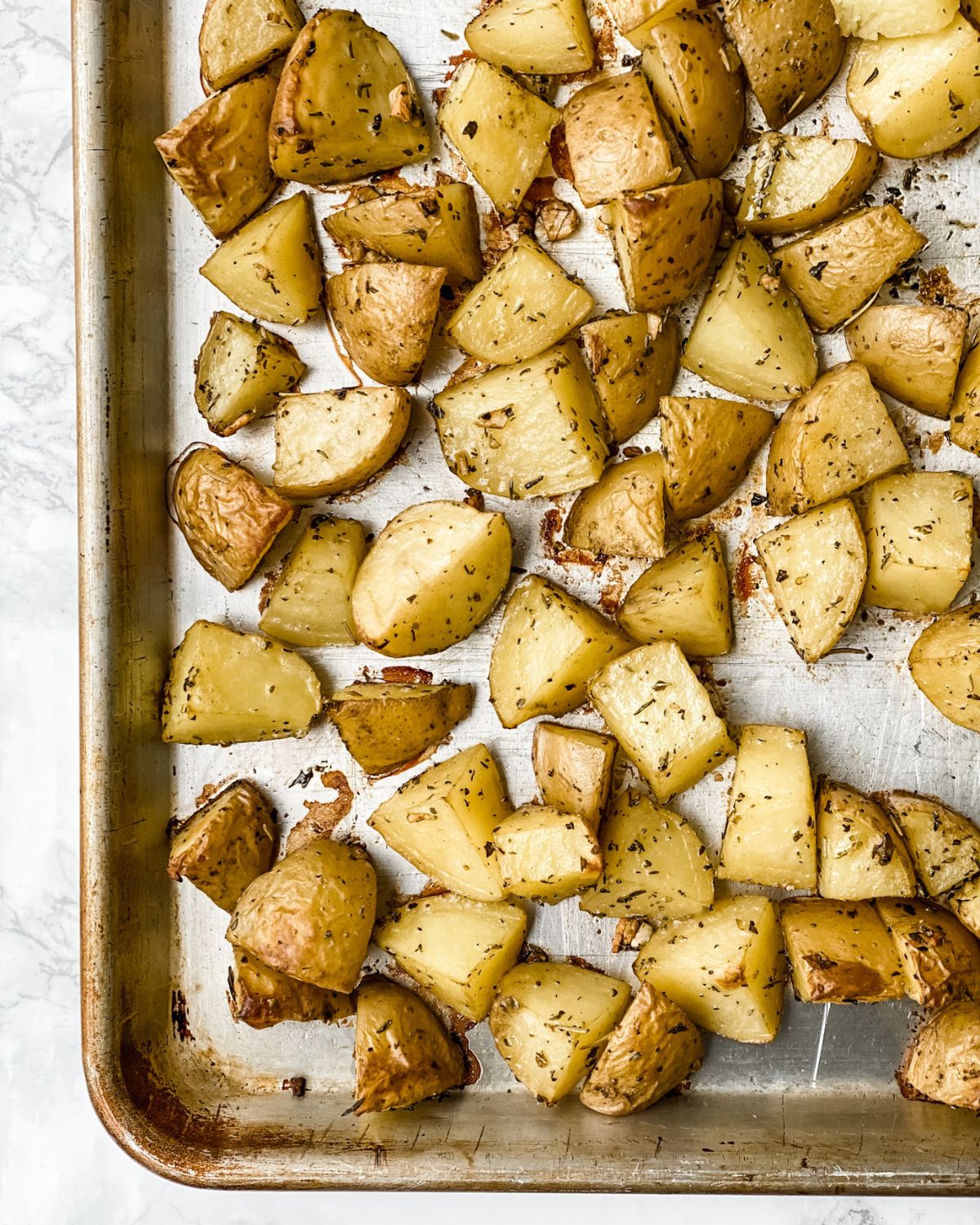 Overhead picture of roasted potatoes on a sheet pan.