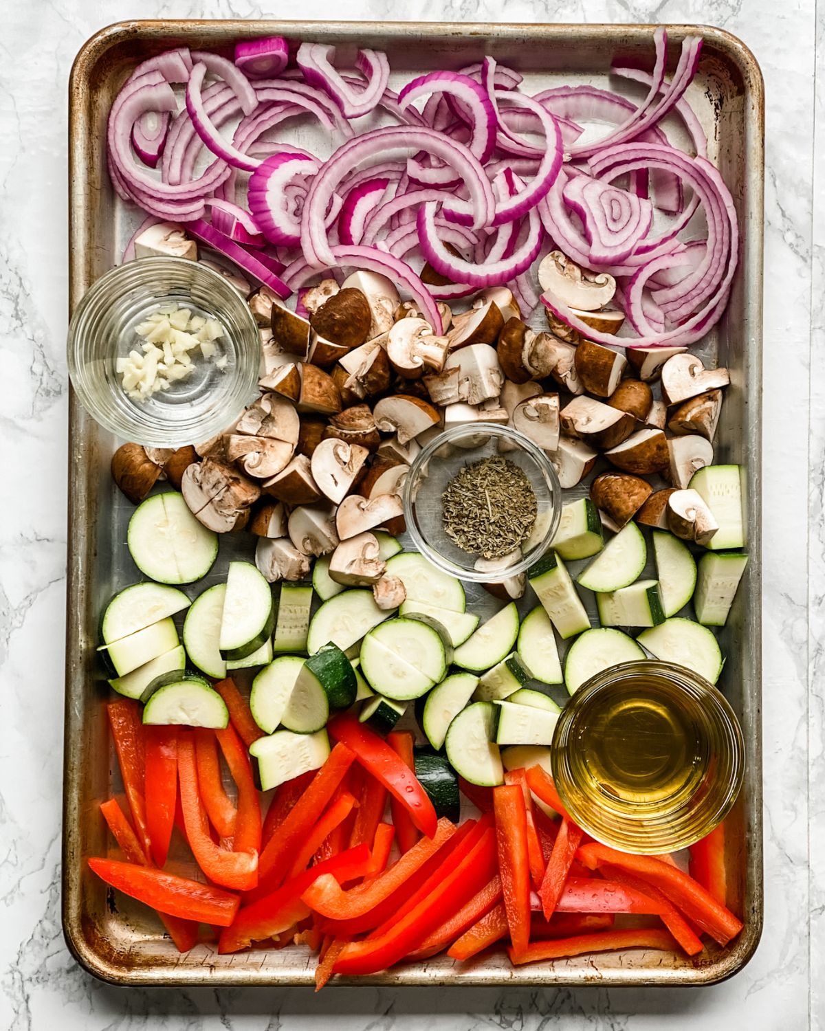 raw vegetables on a baking sheet.