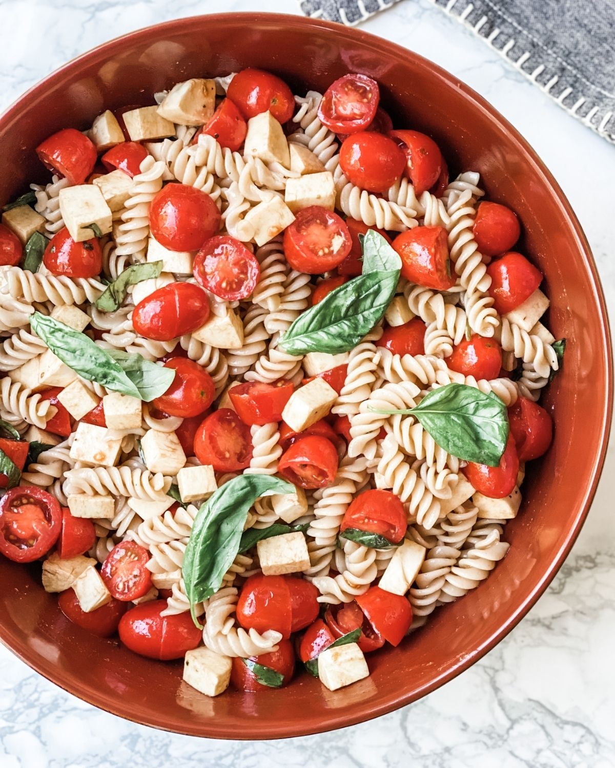 overhead picture of caprese pasta salad in a bowl.