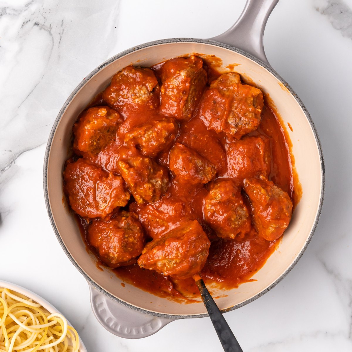 turkey meatballs in a pot with sauce.