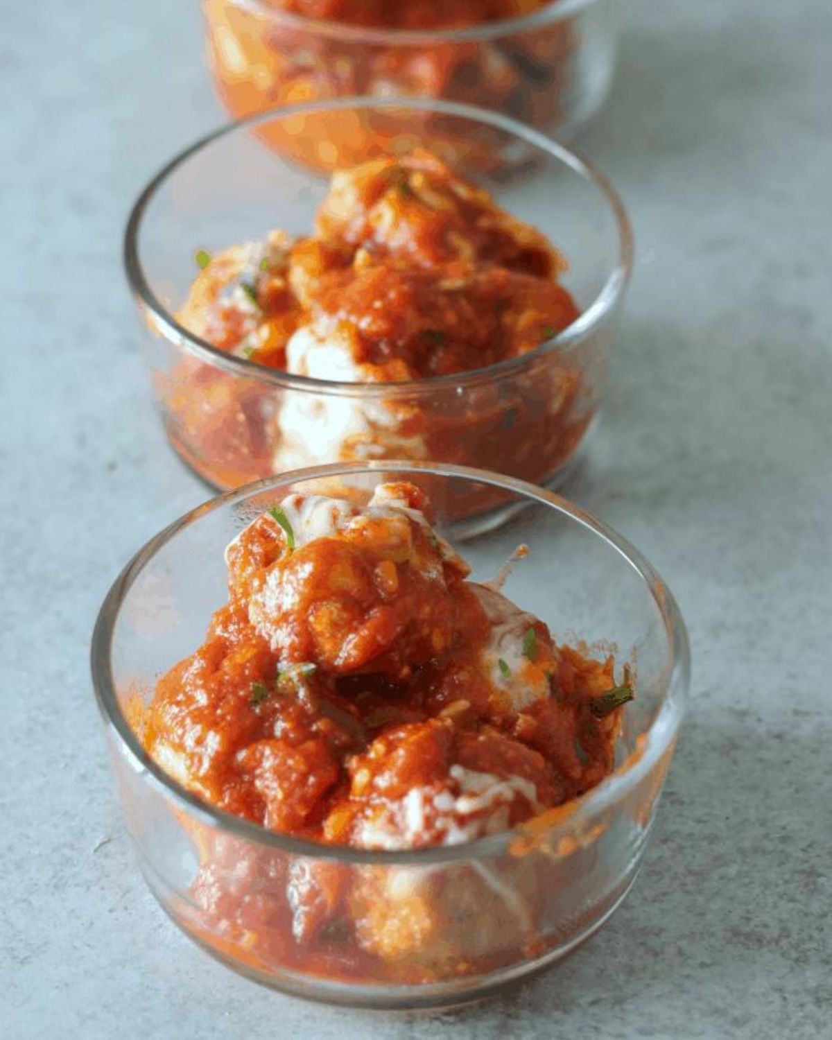 gluten free chicken meatball parmesan in glass containers.