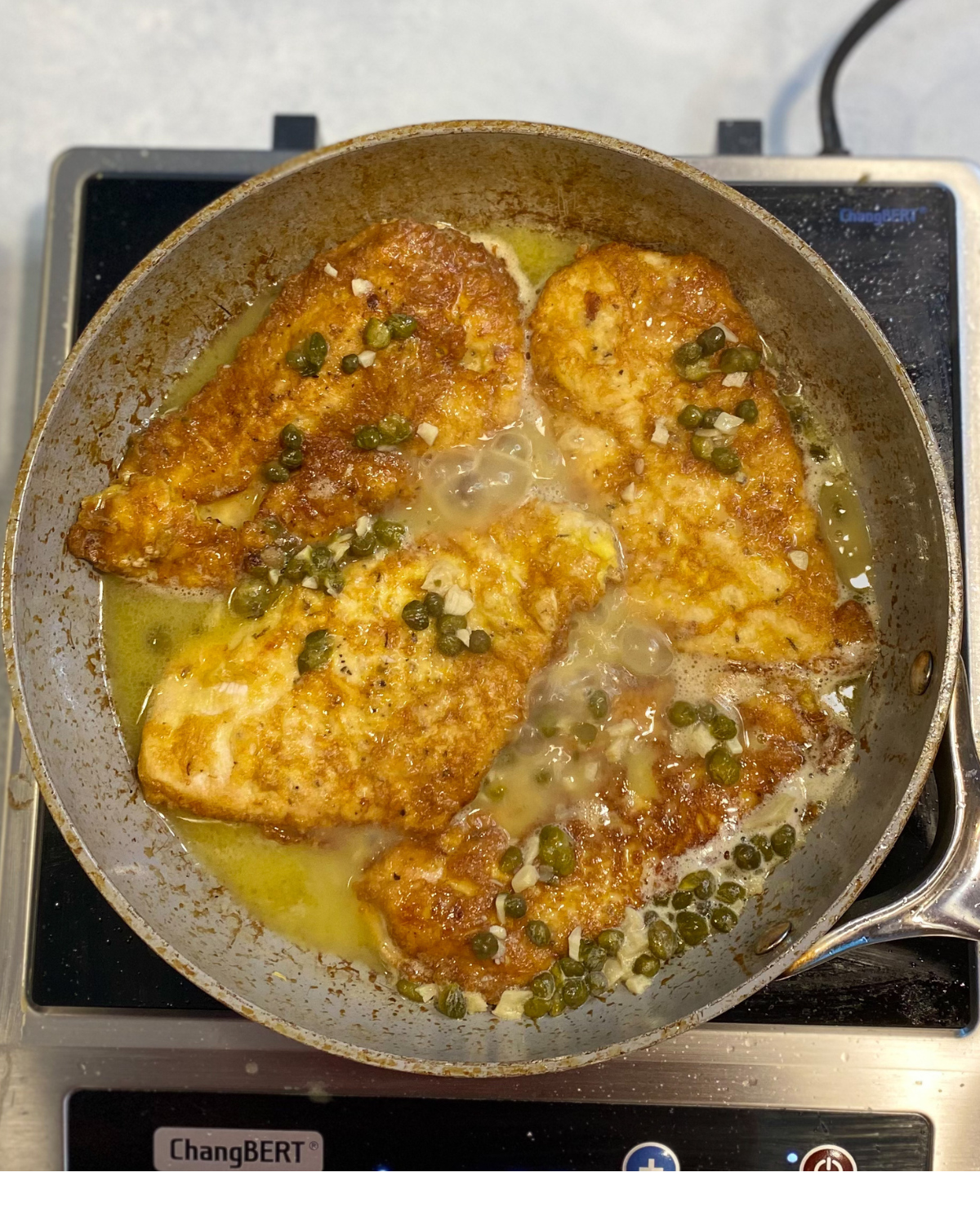 chicken in pan with caper sauce