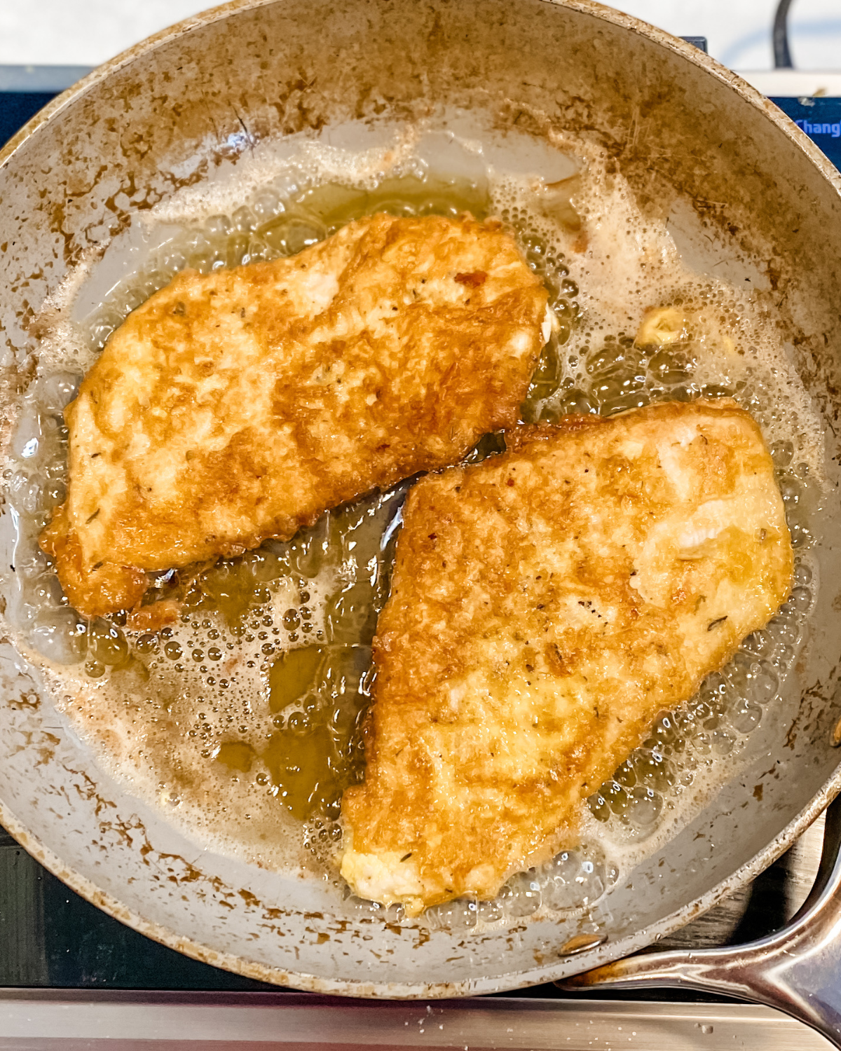 cooked egg battered chicken cutlets in pan