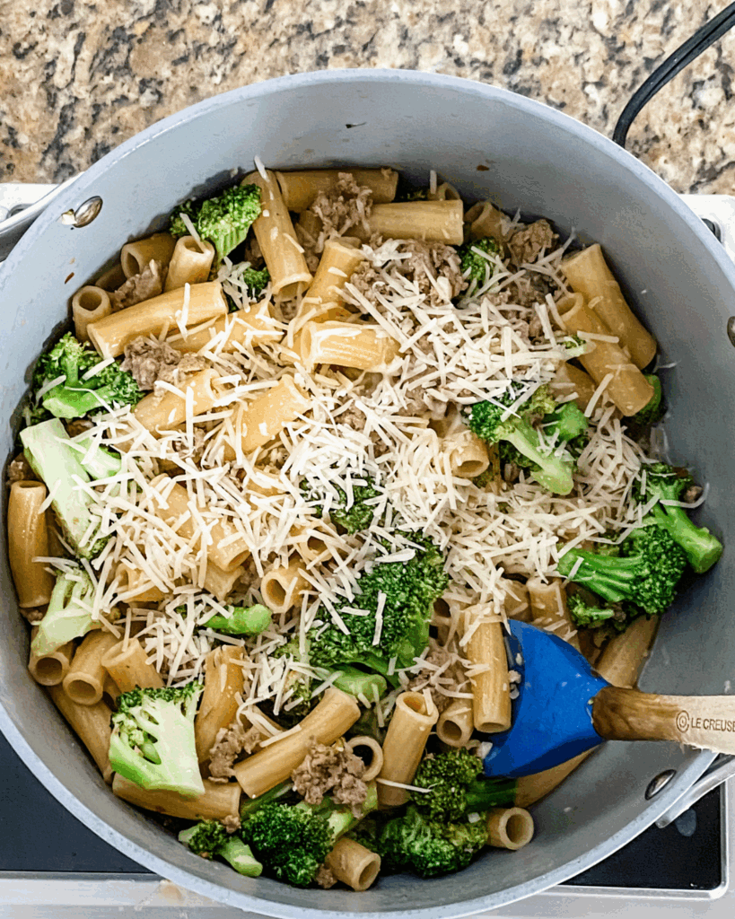 add grated cheese into the pasta and broccoli.