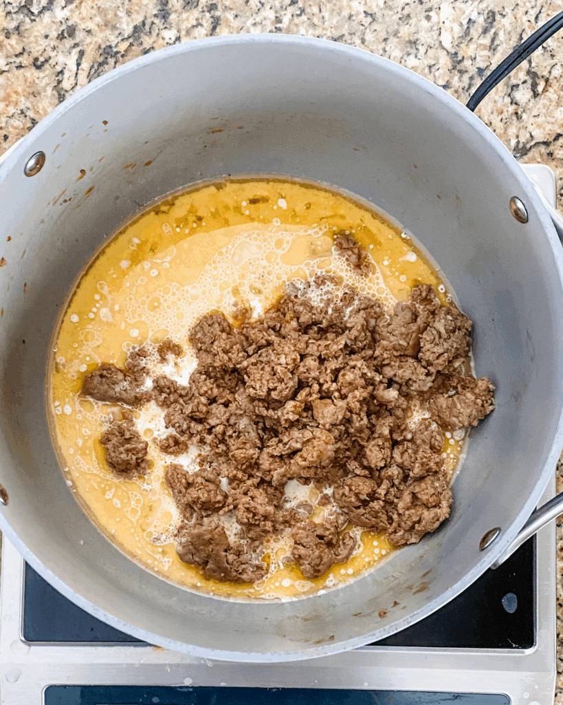 add in cream and sausage to pot
