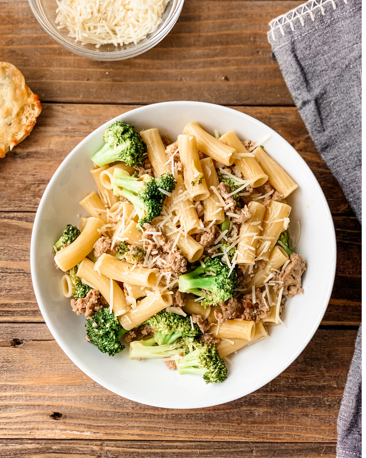 Overhead picture of sausage pasta broccoli on a white place.