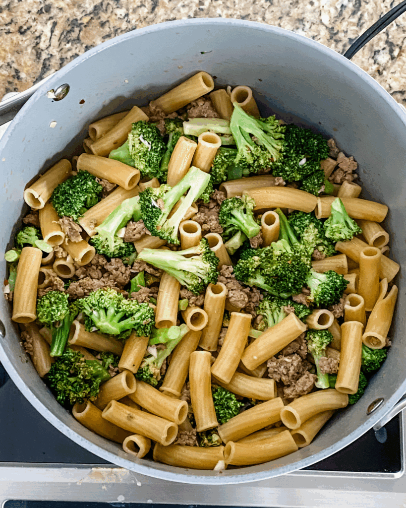 stir together pasta and broccoli.