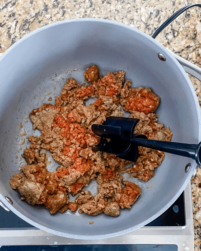 raw sausage in a pot cooking