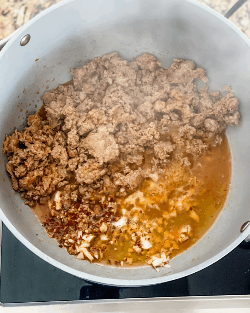 cooked italian sausage with wine and broth.